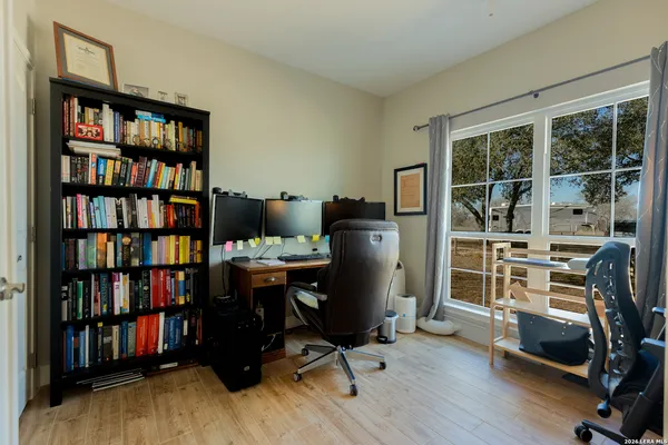 a living room with baby crib furniture and a window