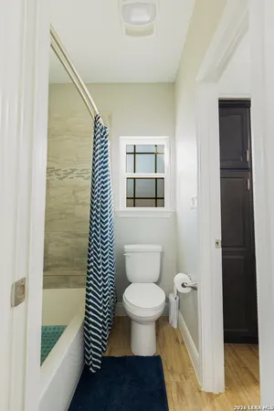 a bathroom with a granite countertop sink and mirror
