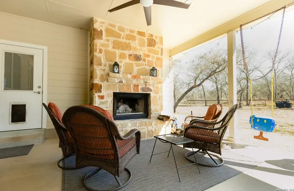 a living room with furniture ceiling fan and a fireplace