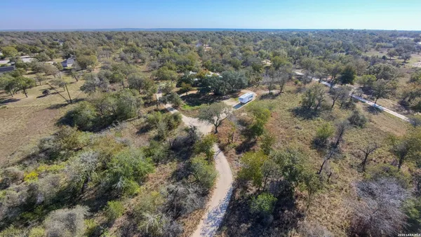 an aerial view of house with yard and mountain