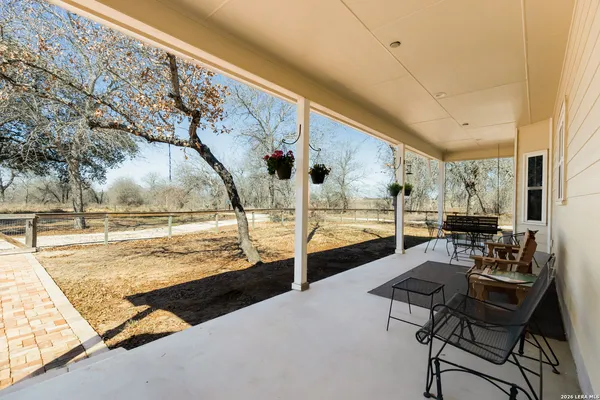 a kitchen with stainless steel appliances granite countertop a table chairs sink refrigerator and microwave