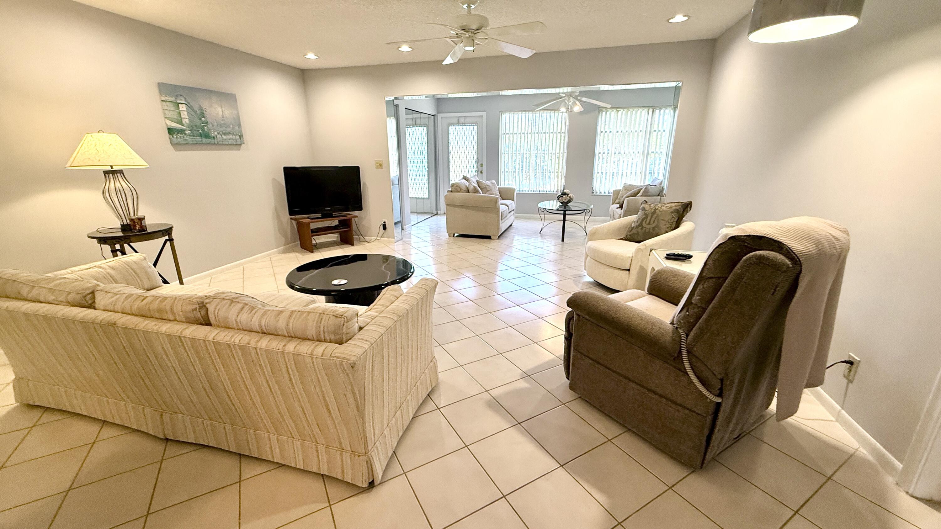 5242 Privet Place Delray Beach, FL 33484 - Photo 11 of 50 a living room with furniture and a flat screen tv