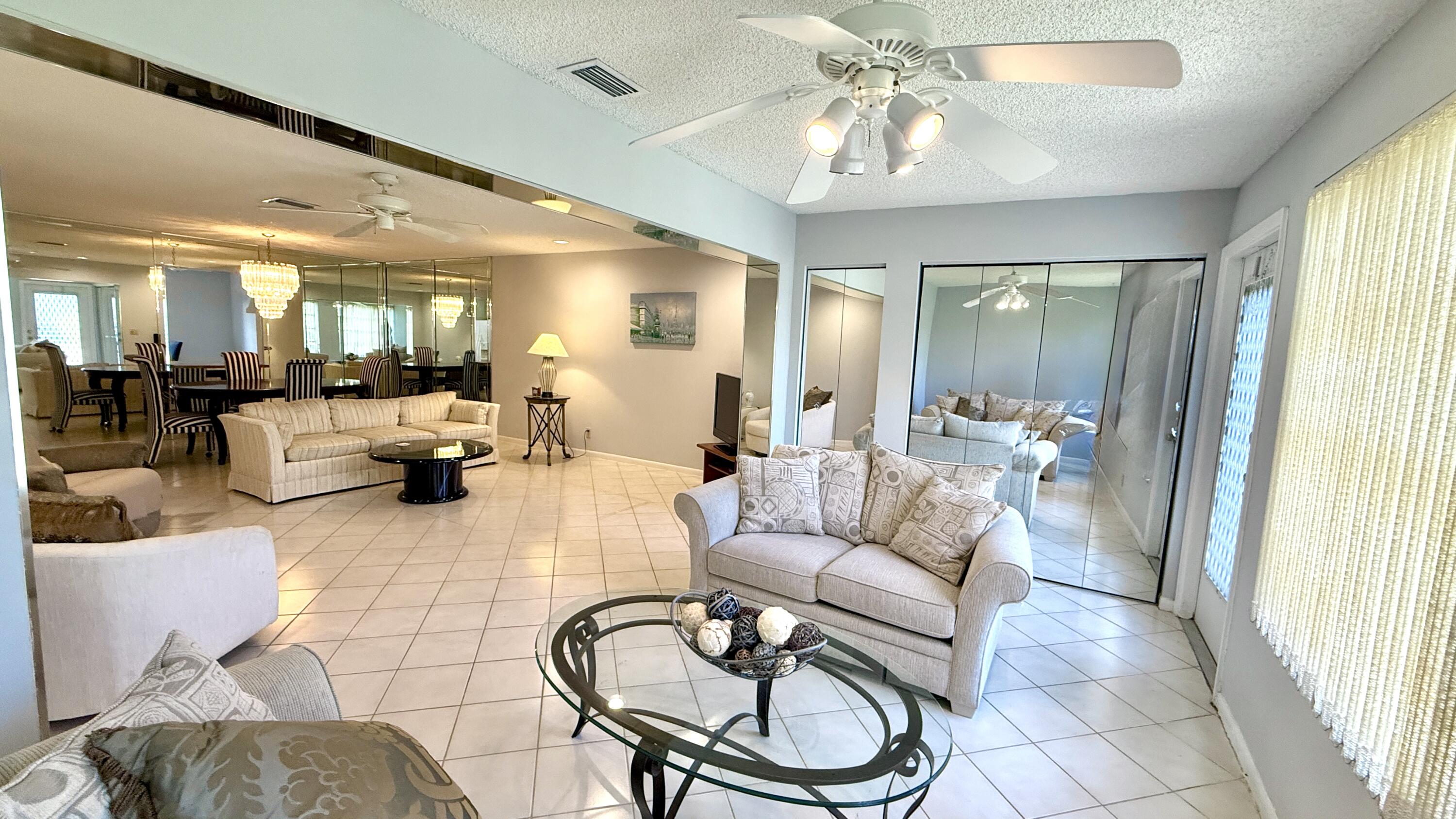 5242 Privet Place Delray Beach, FL 33484 - Photo 14 of 50 a living room with furniture a chandelier and a chandelier