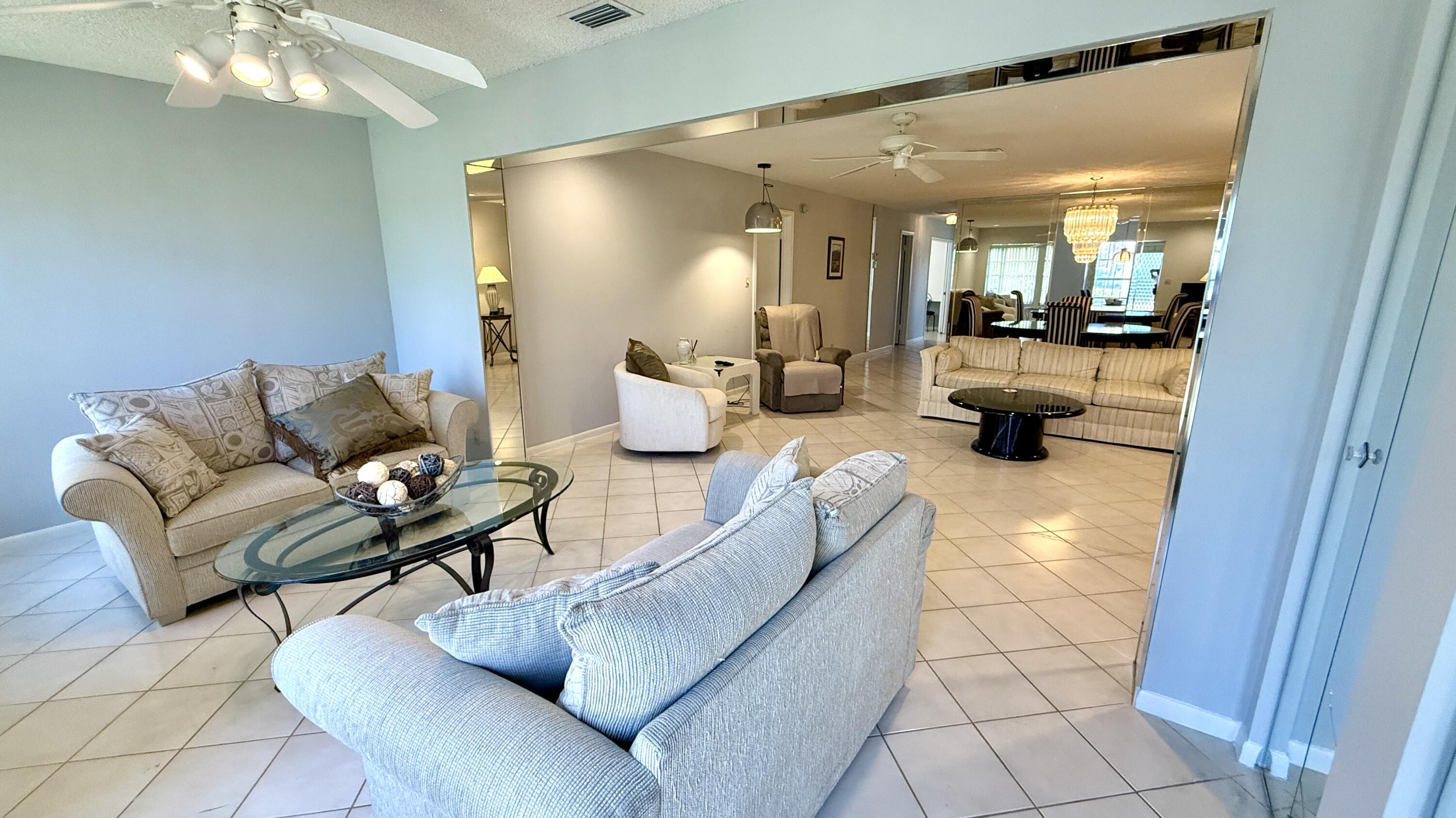 5242 Privet Place Delray Beach, FL 33484 - Photo 15 of 50 a living room with furniture and a chandelier
