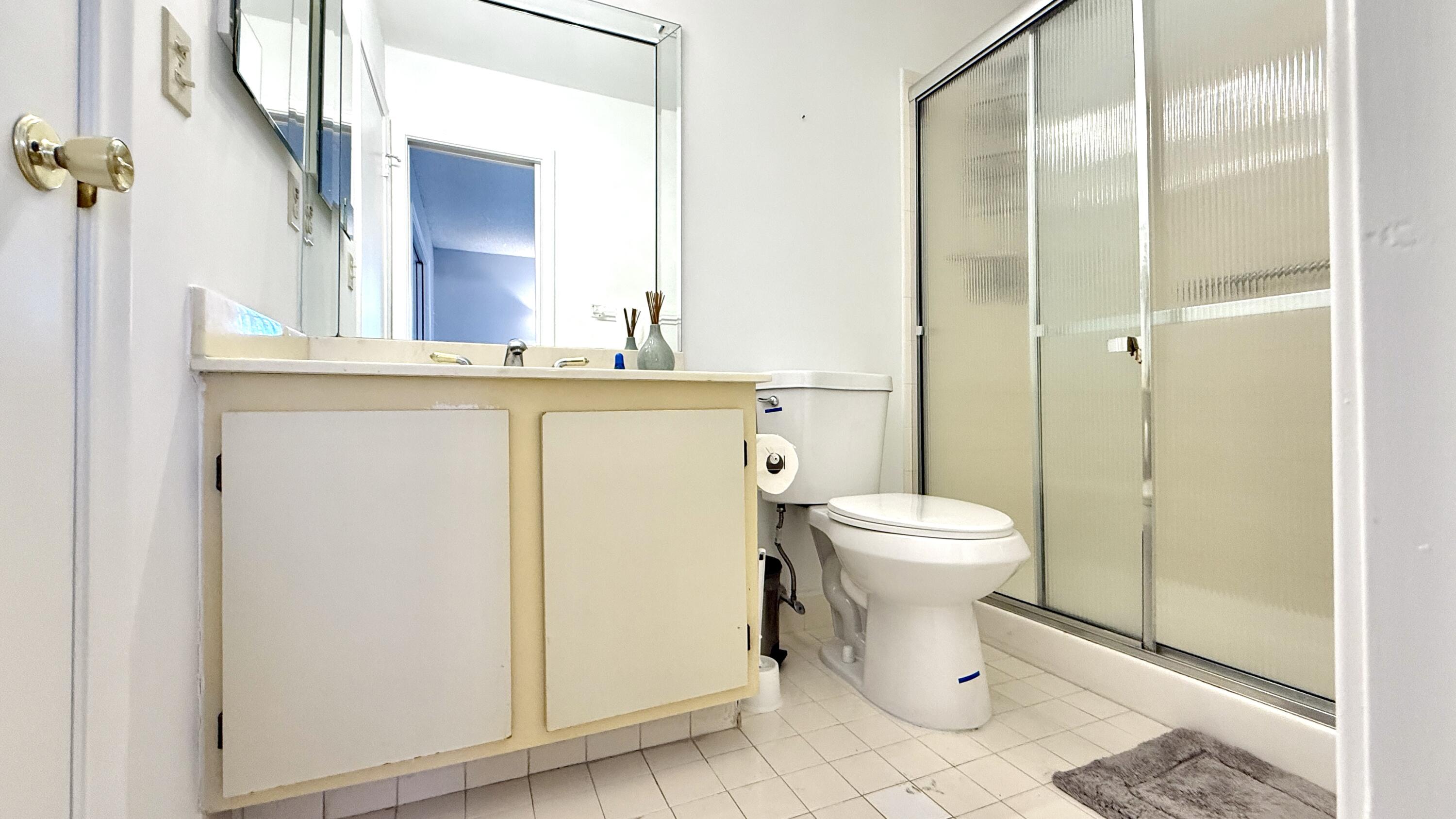 5242 Privet Place Delray Beach, FL 33484 - Photo 20 of 50 a bathroom with a granite countertop toilet and a sink
