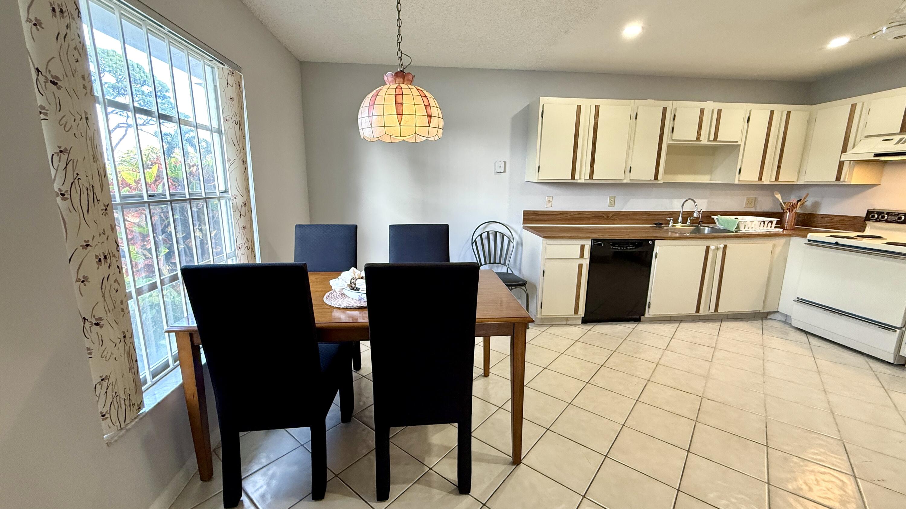 5242 Privet Place Delray Beach, FL 33484 - Photo 7 of 50 a view of a dining room with furniture and a kitchen