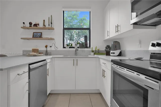 a kitchen with a sink stove top oven and cabinets