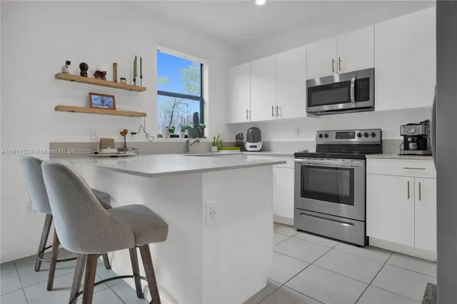a kitchen with a stove a sink and a refrigerator