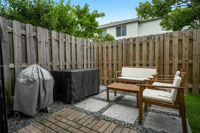 a backyard of a house with table and chairs