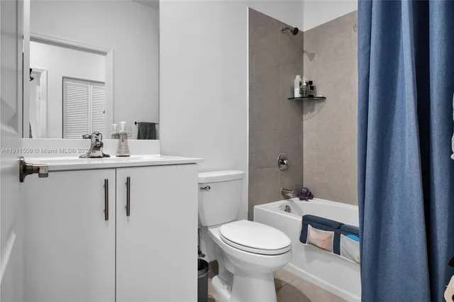 a bathroom with a toilet a sink and a mirror