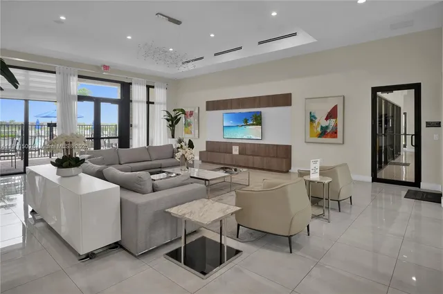 a living room with fireplace furniture and a large window