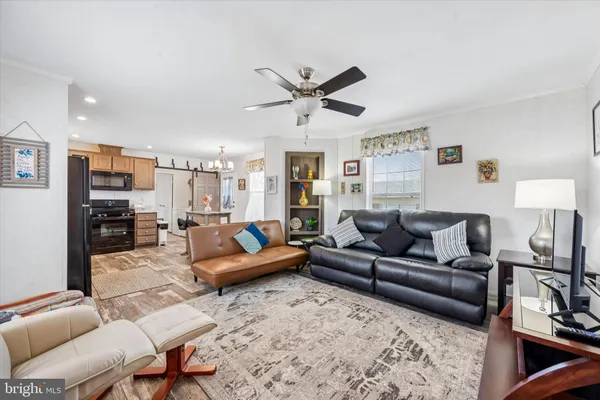 a living room with furniture or couch and a ceiling fan