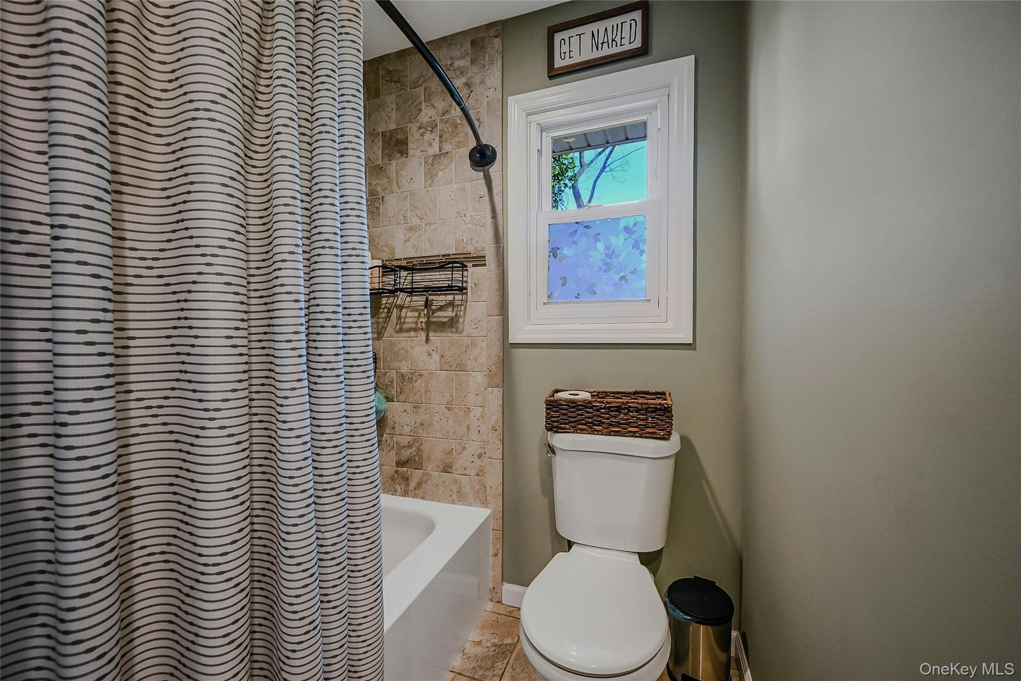 4 Park Road Rocky Point, NY 11778 - Photo 25 of 38 a white toilet sitting next to a shower curtain