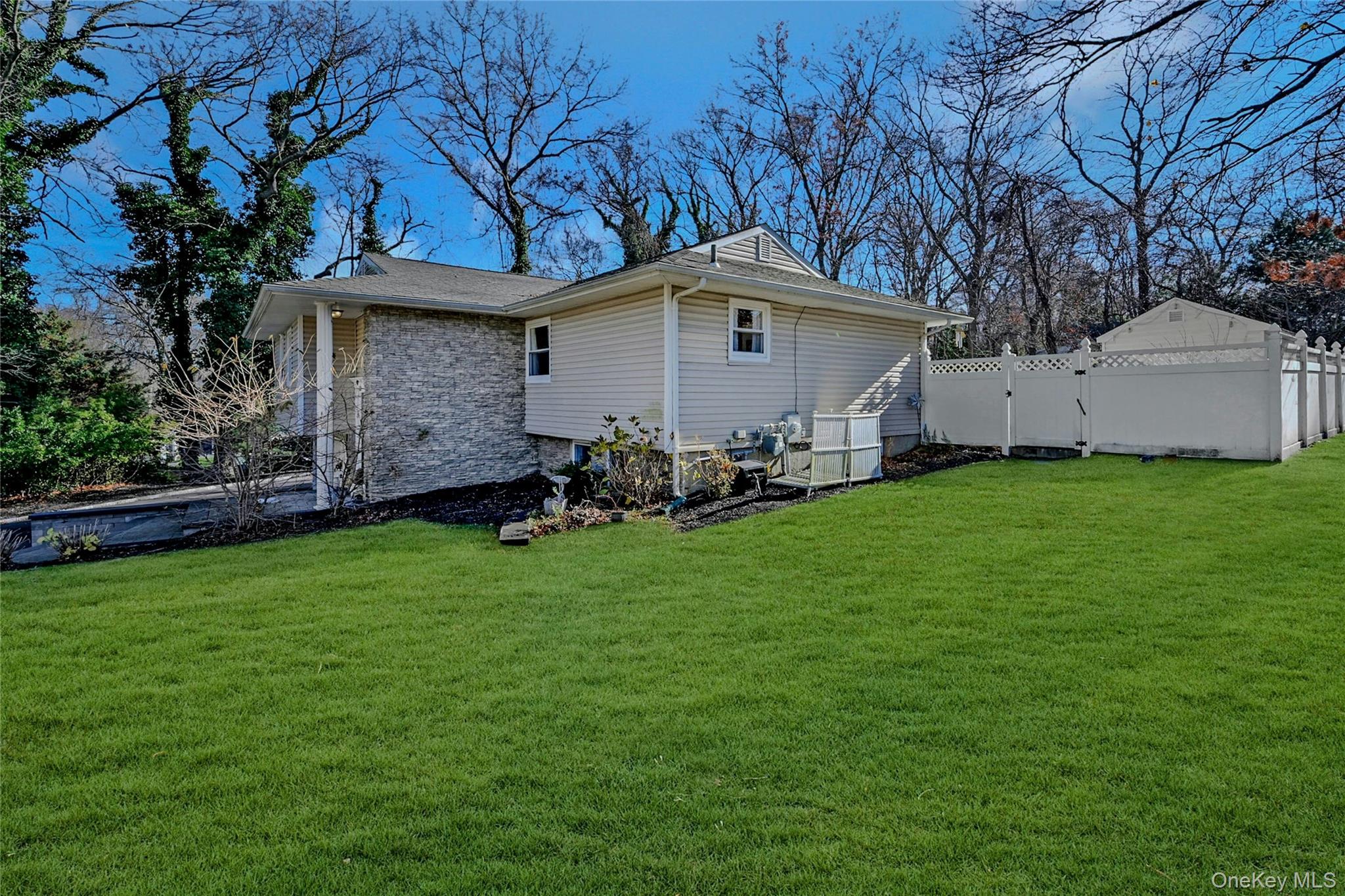 4 Park Road Rocky Point, NY 11778 - Photo 29 of 38 a front view of house with yard and trees in the background