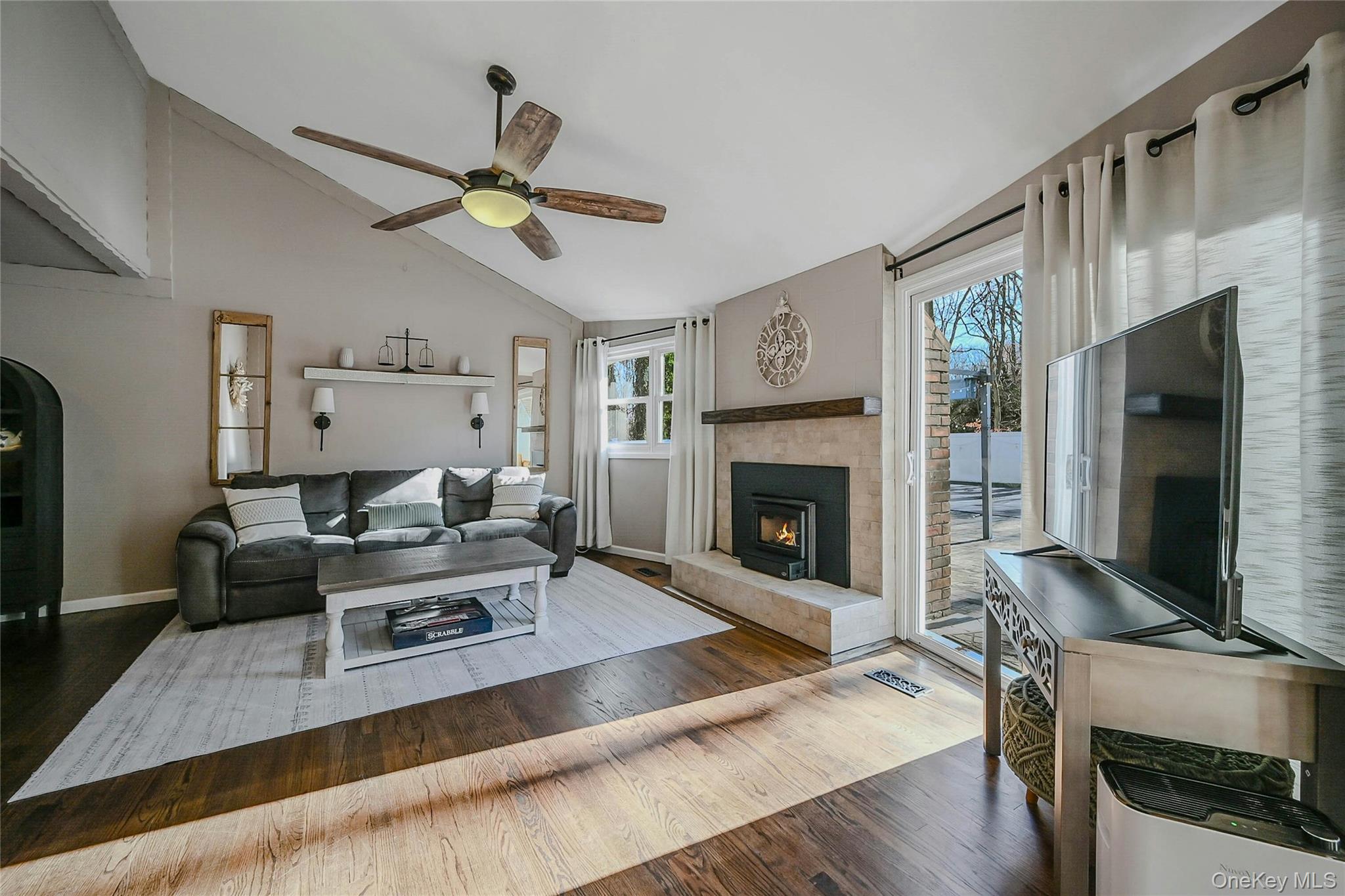4 Park Road Rocky Point, NY 11778 - Photo 7 of 38 a living room with furniture a fireplace and a flat screen tv