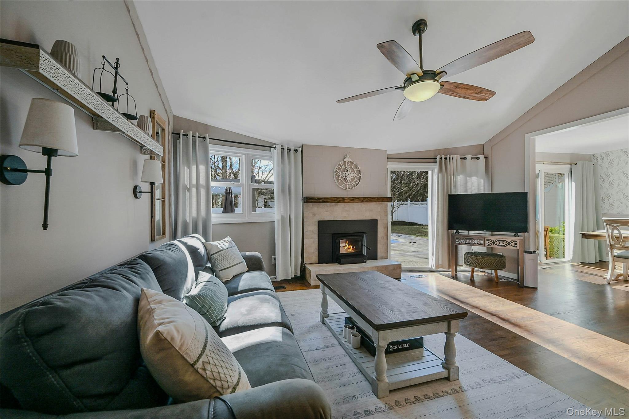 4 Park Road Rocky Point, NY 11778 - Photo 10 of 38 a living room with furniture a flat screen tv and a fireplace