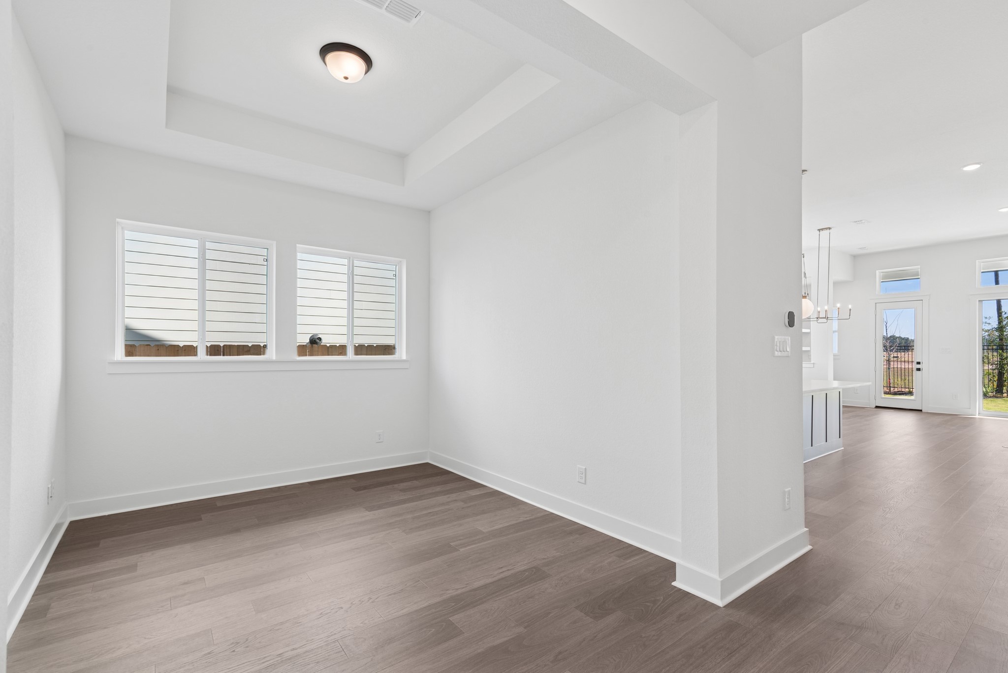 16138 Rita Road Conroe, TX 77302 - Photo 17 of 50 an empty room with wooden floor and windows