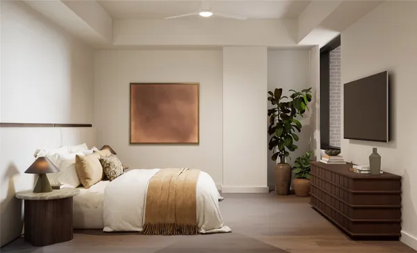 a bedroom with a bed and a flat screen tv