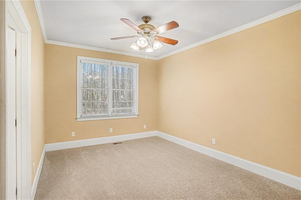 390 Glengarry Chase Covington, GA 30014 - Photo 15 of 21 an empty room with ceiling fan and window