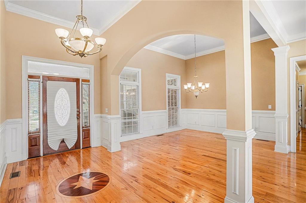 390 Glengarry Chase Covington, GA 30014 - Photo 3 of 21 a bedroom with a bed and a chandelier