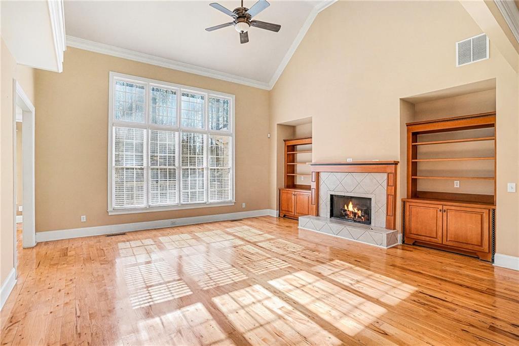 390 Glengarry Chase Covington, GA 30014 - Photo 4 of 21 a view of an empty room with a fireplace and a window