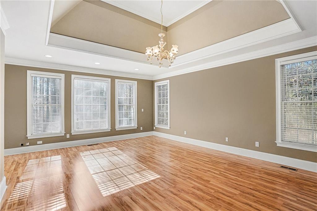 390 Glengarry Chase Covington, GA 30014 - Photo 10 of 21 a view of an empty room with wooden floor and a window
