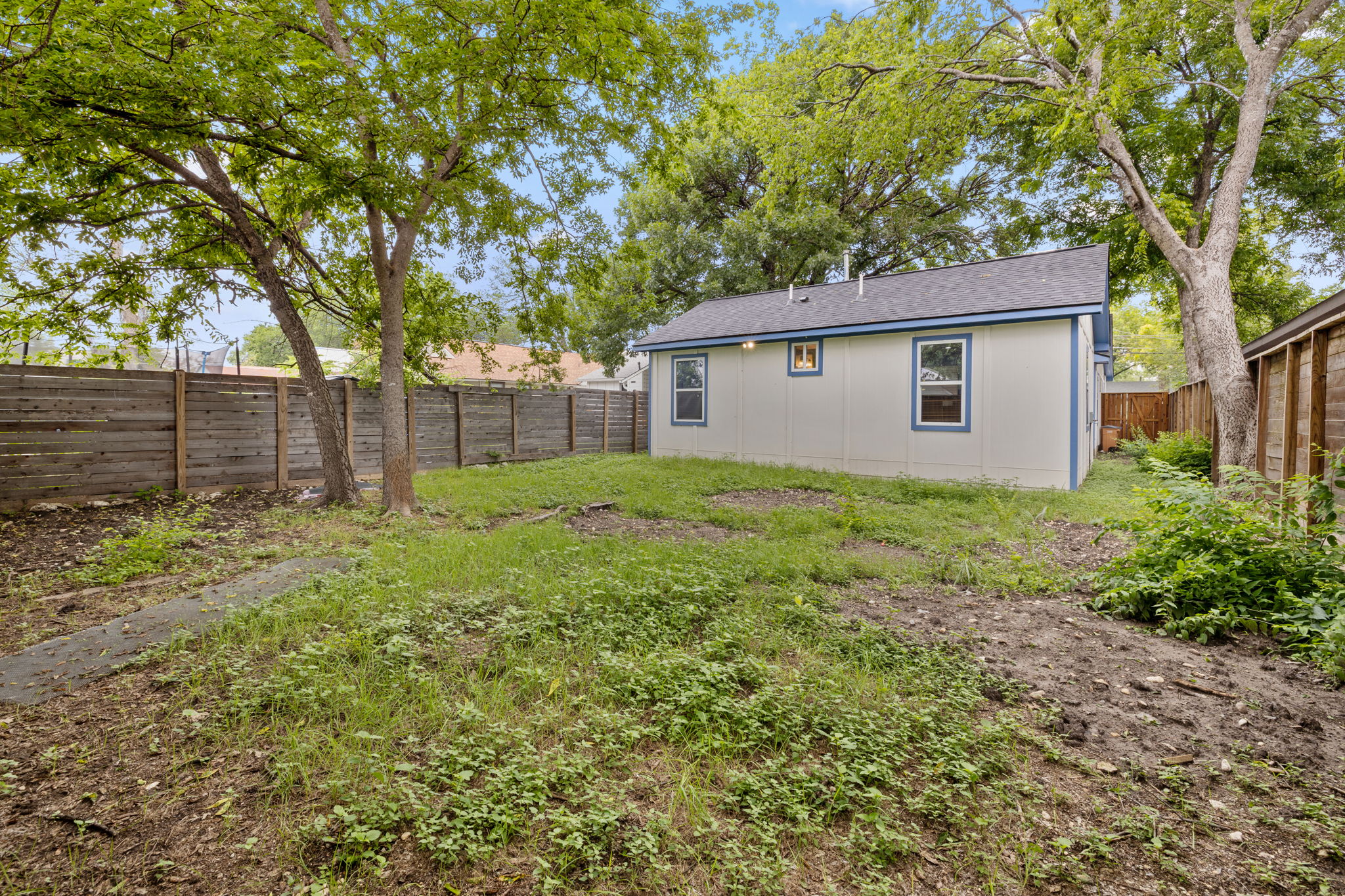 907 East 53rd Street Austin, TX 78751 - Photo 33 of 36 A private yard with mature trees and perimeter fencing offers a tranquil outdoor retreat.