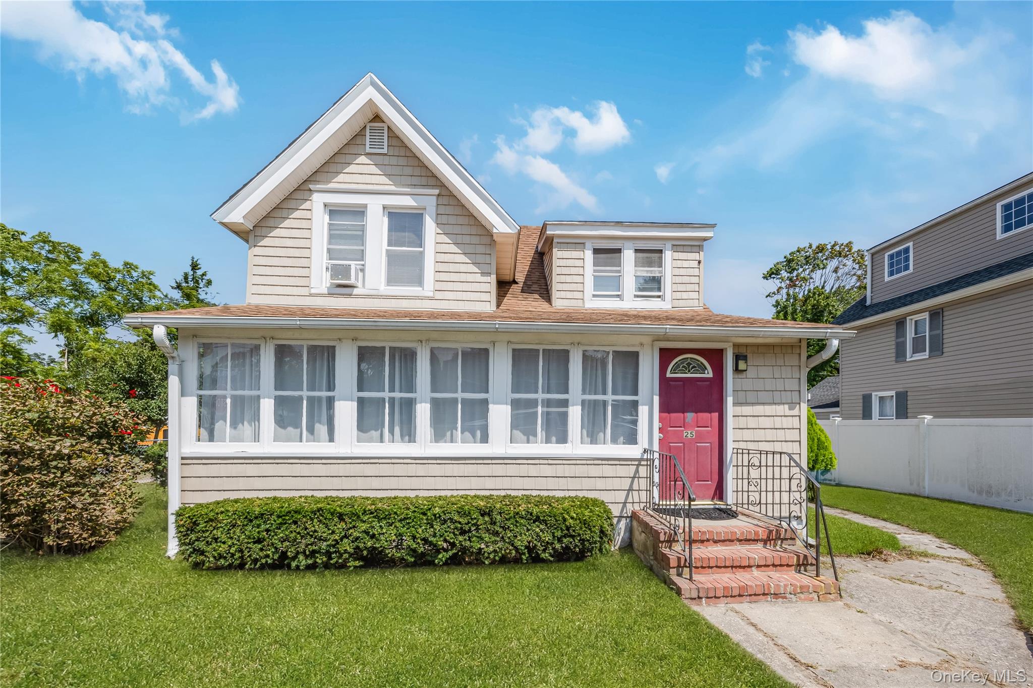 25 1st Street Islip, NY 11751 - Photo 1 of 1 a front view of a house with a garden