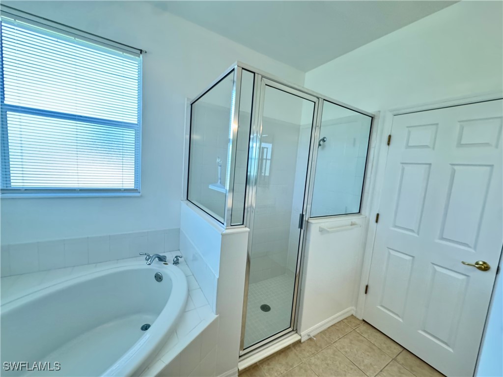12635 Stone Tower Loop Fort Myers, FL 33913 - Photo 15 of 27 a bathroom with a bathtub and a shower