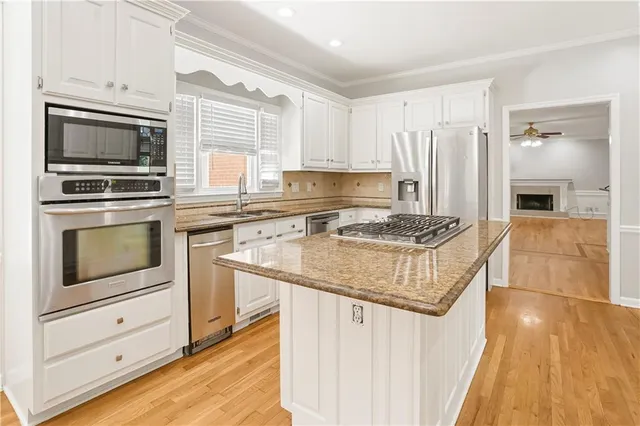 a view of a room with wooden floor and chandelier