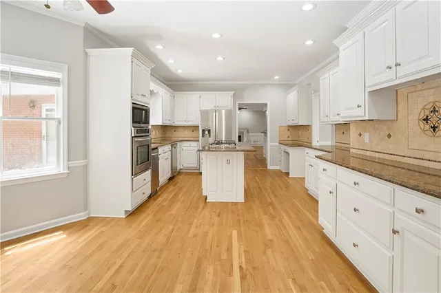 a large bathroom with a tub a sink and mirror