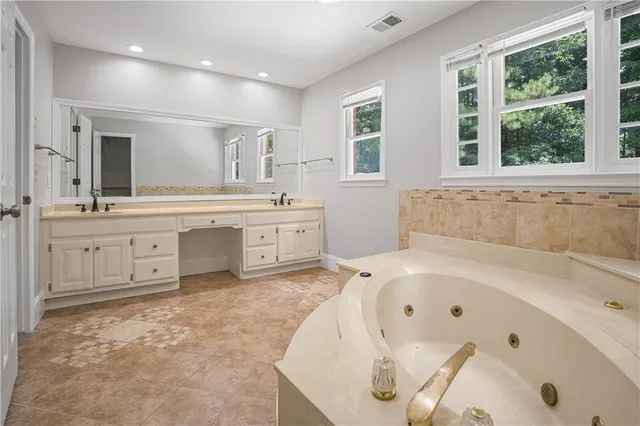 an empty room with a window and a ceiling fan