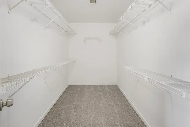 a view of an empty room with a fireplace and a window