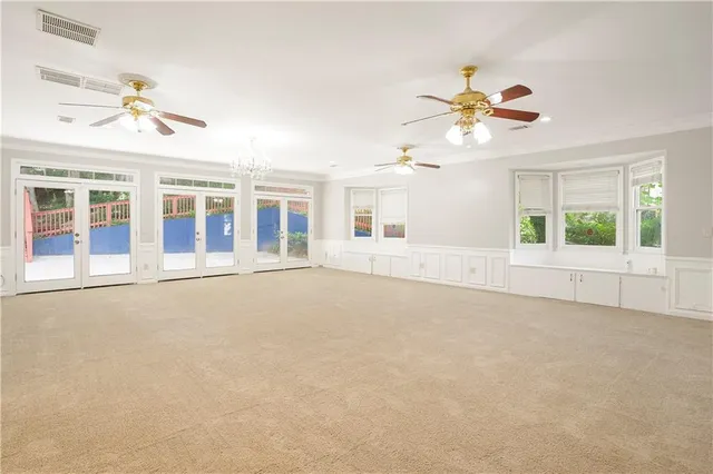 a large kitchen with stainless steel appliances lots of counter space and wooden floors