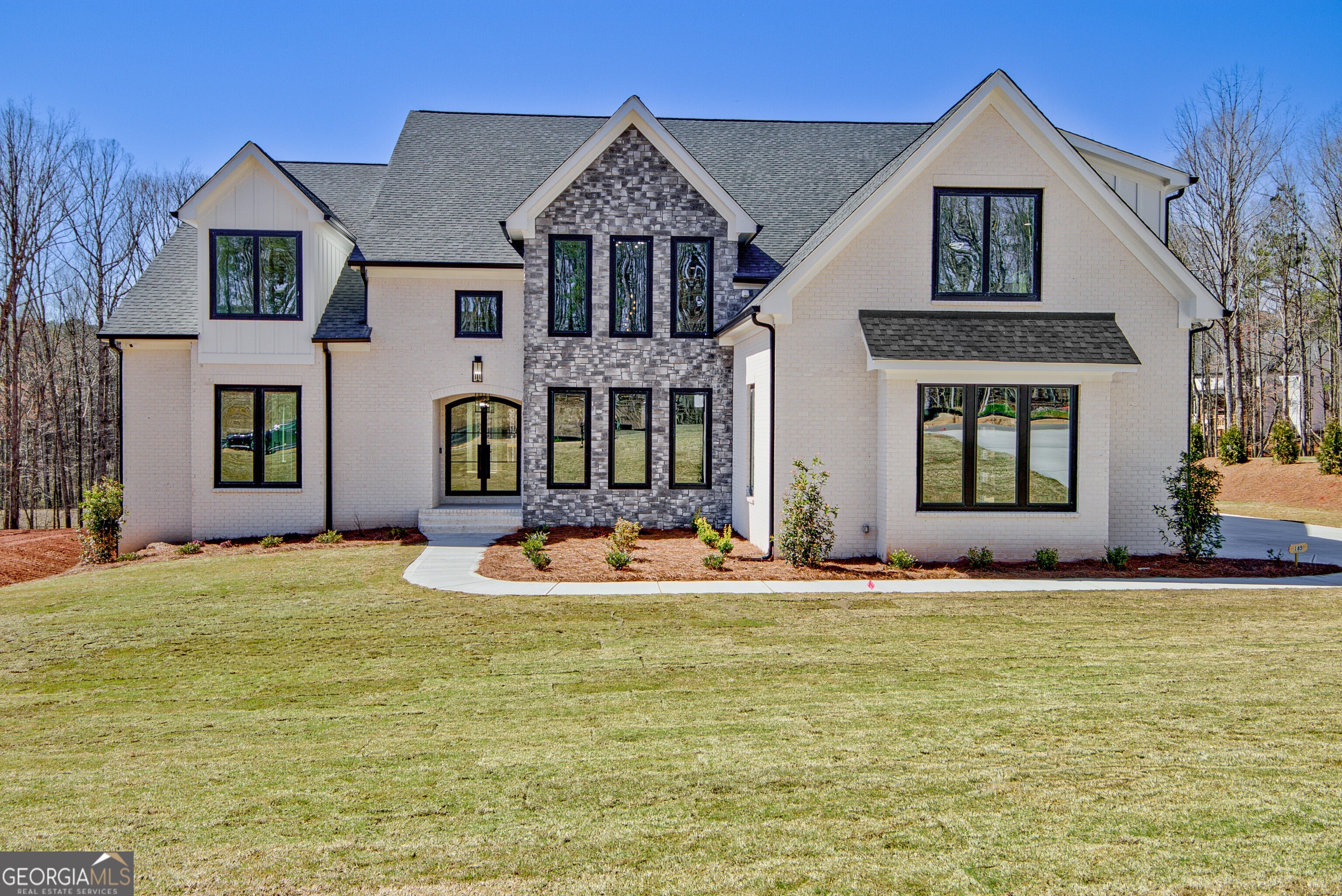 a front view of a house with a yard