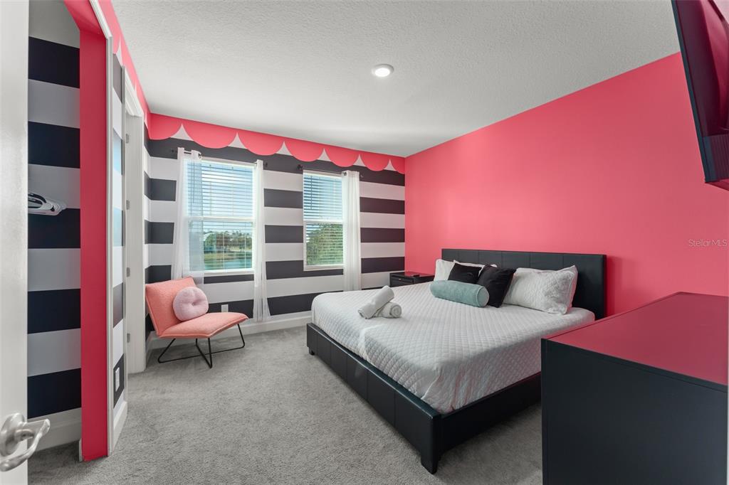 1531 Fairview Circle Reunion, FL 34747 - Photo 20 of 42 a bedroom with a bed and a chair