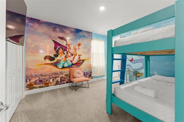 a bed room with a bed and painting on the wall