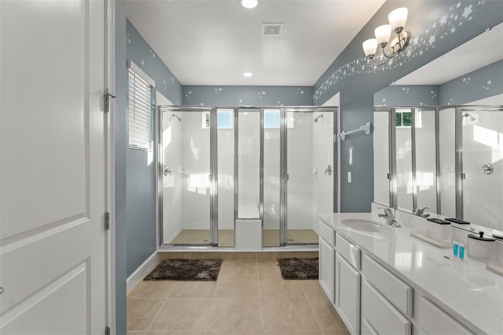 1531 Fairview Circle Reunion, FL 34747 - Photo 34 of 42 a bathroom with a double vanity sink and mirror with shower