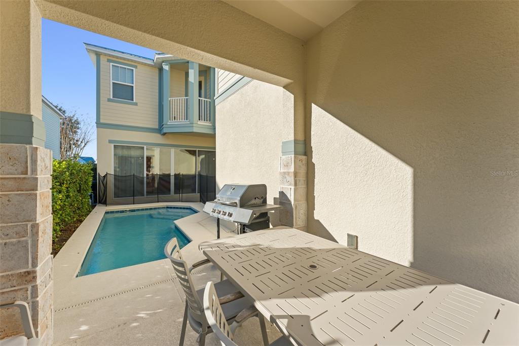 1531 Fairview Circle Reunion, FL 34747 - Photo 40 of 42 a view of a patio with table and chairs with wooden floor and fence