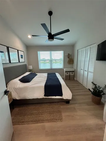 a bathroom with a granite countertop sink a toilet a mirror and shower