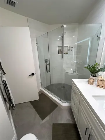 a bathroom with a sink toilet and shower