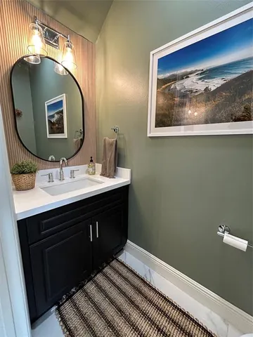a bathroom with a sink vanity and a mirror