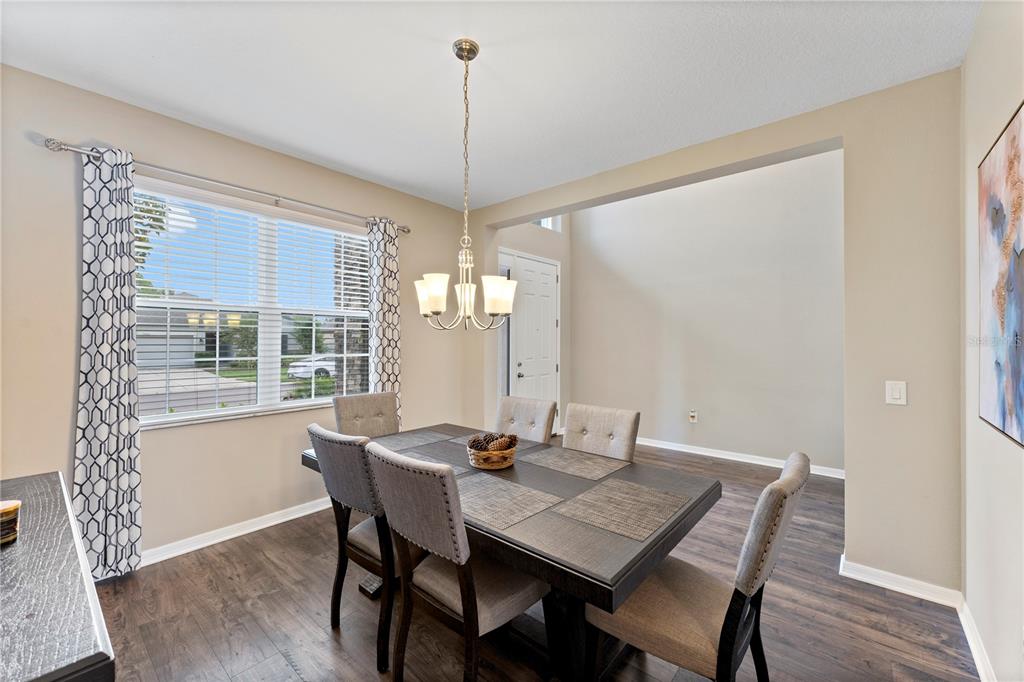 19065 Malinche Loop Spring Hill, FL 34610 - Photo 12 of 72 a view of a dining room with furniture window and wooden floor