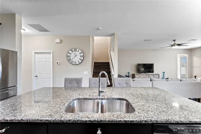 a dining room with furniture a chandelier and wooden floor