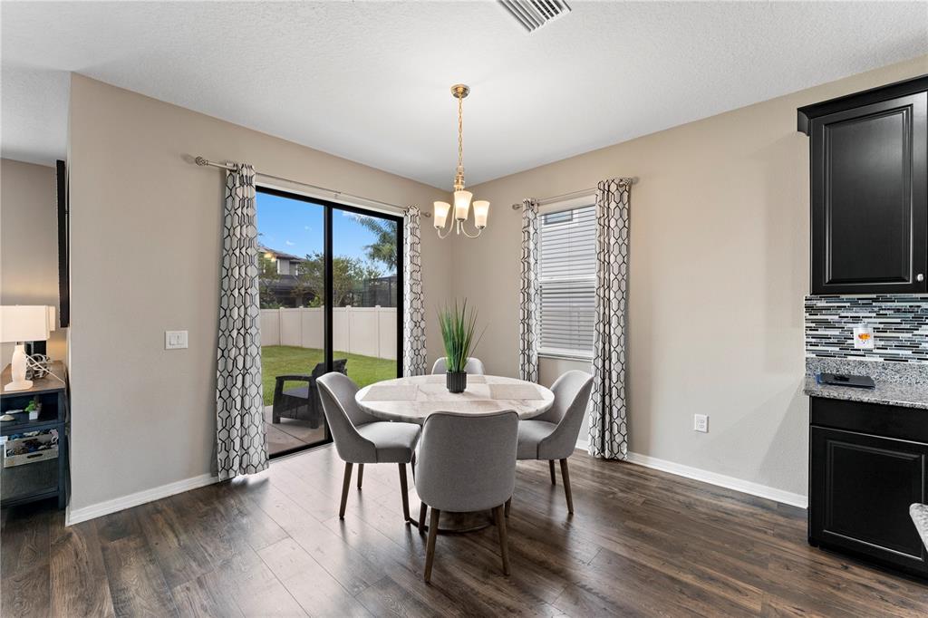 19065 Malinche Loop Spring Hill, FL 34610 - Photo 25 of 72 a dining room with furniture window and wooden floor