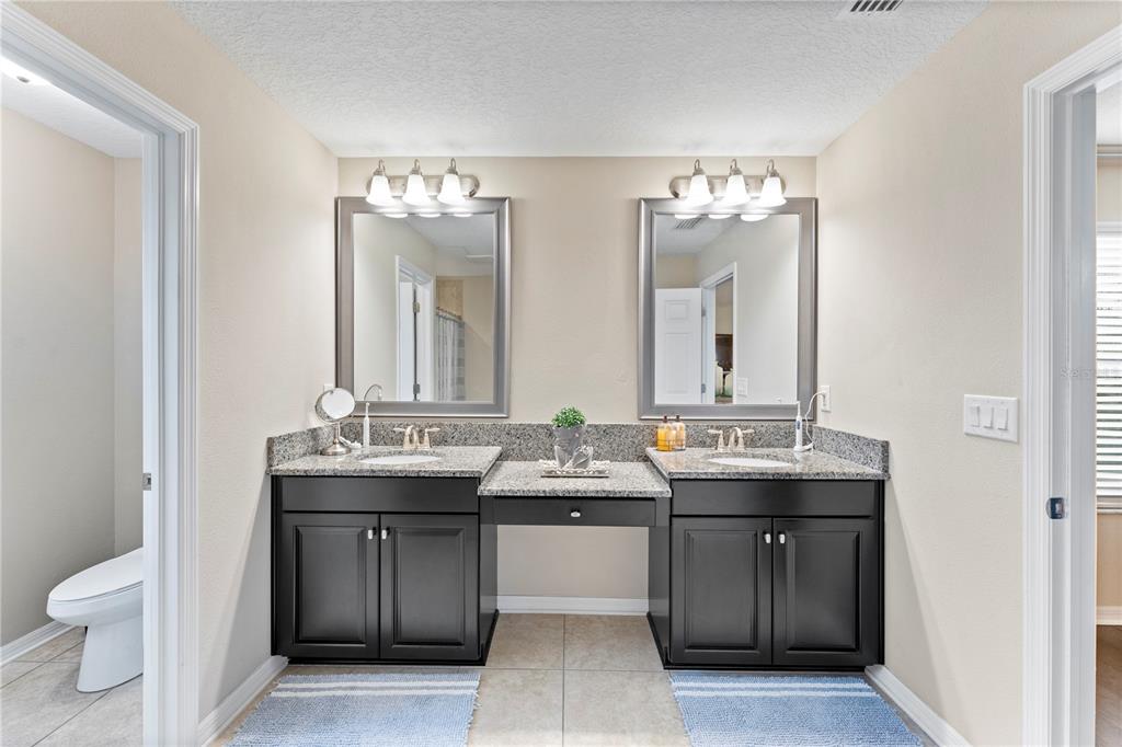 19065 Malinche Loop Spring Hill, FL 34610 - Photo 46 of 72 a bathroom with a sink double vanity and a mirror