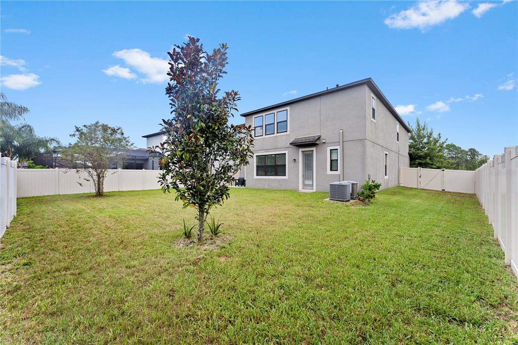 19065 Malinche Loop Spring Hill, FL 34610 - Photo 56 of 72 a view of a house with backyard and garden