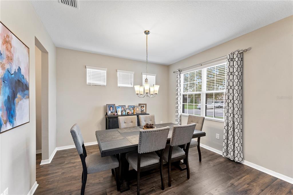 19065 Malinche Loop Spring Hill, FL 34610 - Photo 8 of 72 a view of a dining room with furniture window and wooden floor