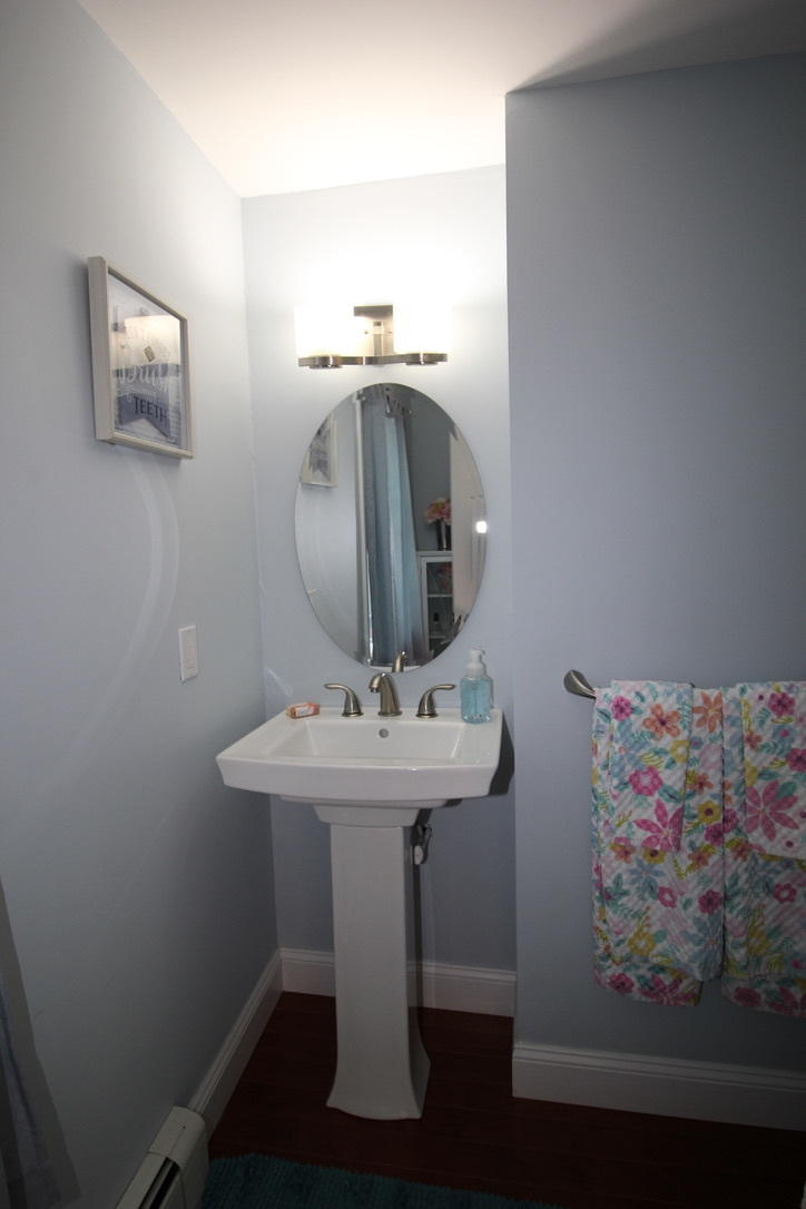 10 Lan Road Sandwich, MA 02563 - Photo 13 of 35 a bathroom with a sink a mirror and painting on the wall