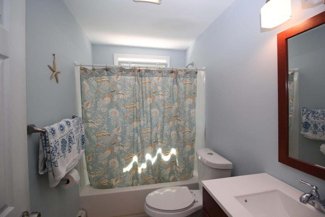 10 Lan Road Sandwich, MA 02563 - Photo 16 of 35 a white toilet sitting next to a shower curtain